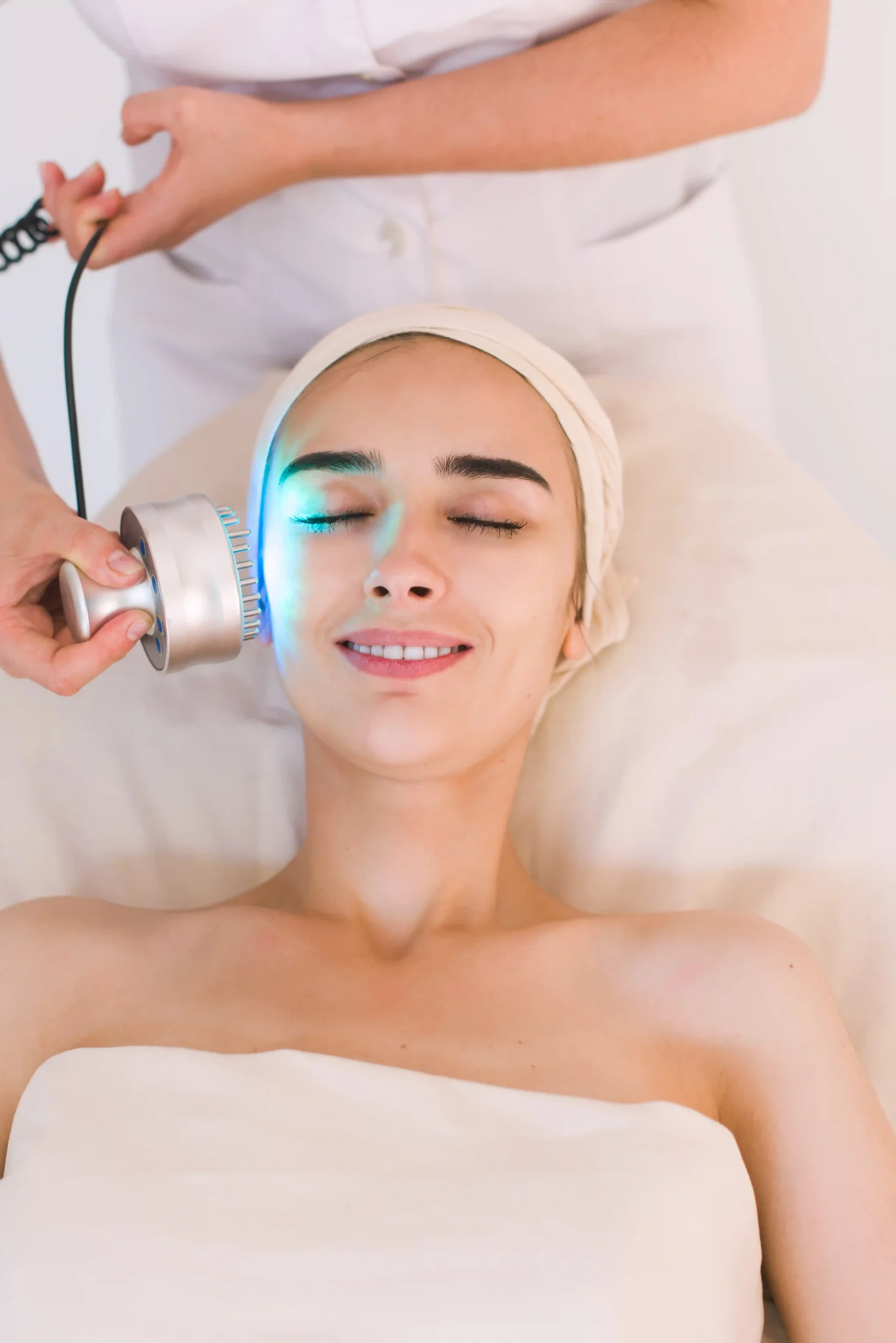 Young woman receiving light-based cosmetic skin treatment at Park City Medesthetix for radiant, smooth skin