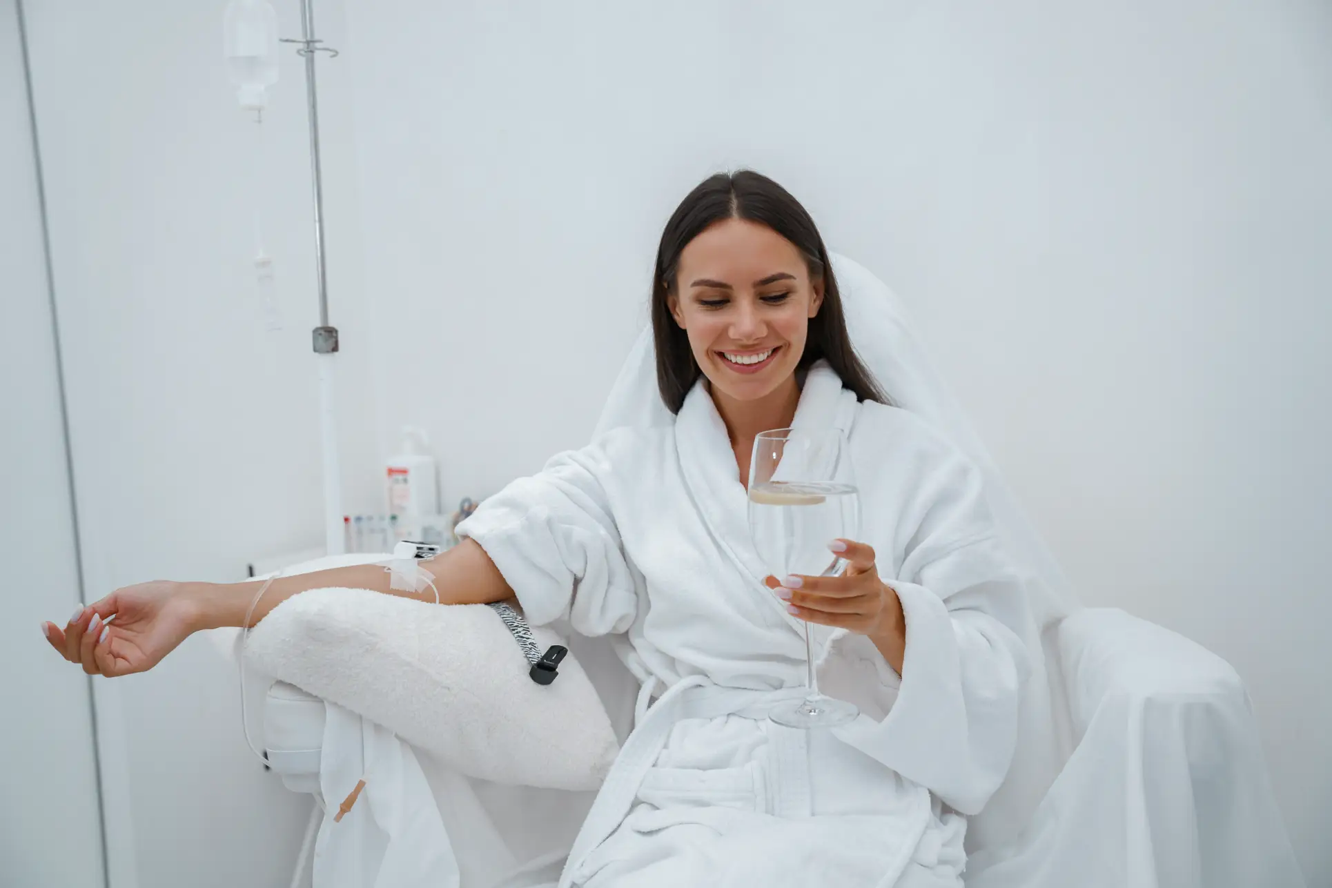 Smiling woman enjoying elevated IV therapy session in a wellness clinic